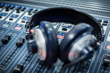 Close-up of radio headphones on sound mixer