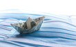 Dollar tosses on the waves. Financial problems concept, banknote origami-ship with surgical masks.