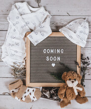Coming Soon Sign. Baby Announcement Sign On A Rustic White Background. Coming Soon Concept. 