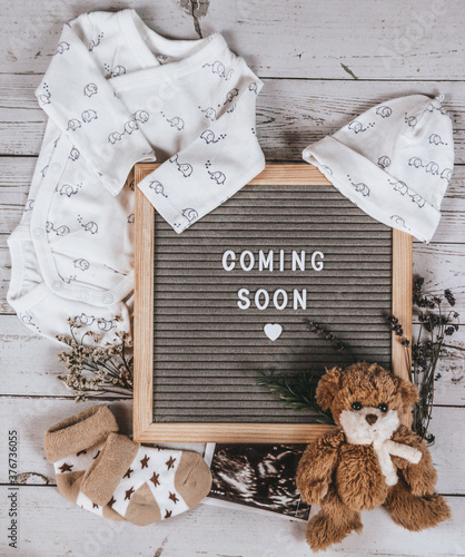 Coming soon sign. Baby announcement sign on a rustic white background. Coming soon concept.