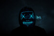 Portrait of an anonymous hacker in a neon mask, Halloween mask