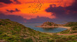 Panoramic landscape of Porticciolo ancient tower at dramatic sunset