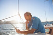 © Connect Images - Man on yacht with digital tablet