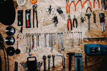 auto mechanic tools hang on garage wall