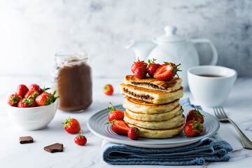 Canvas Print - Pancakes with chocolate nutella filling decorated with strawberries