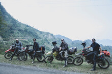 Four Men With Their Motorcycles In Rural Landscape, Vietnam