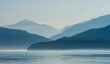 © Tandem Stock - Scenic view of fog over mountain range and sea