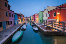 Exterior View Of Colorful Houses With Boats Moored In Canal, Burano Island, Venice, Italy