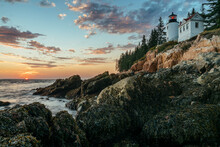 View Of Lighthouse On Coast In Acadia National Park During Sunset