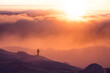 © Tandem Stock - Rear view of woman skiing on snowy landscape during sunset