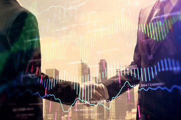 Double exposure of forex graph hologram and handshake of two men. Stock market concept.