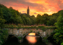 Scenic View Of University Of Glasgow With Bridge In Foreground During Sunrise