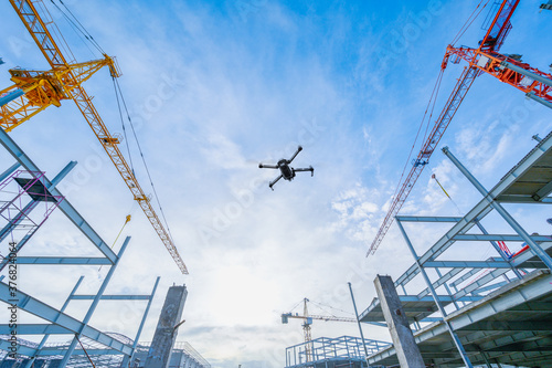 Drone over construction site. video surveillance or industrial inspection