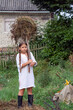 © Вера Щербакова - Girl in a white shirt cleans up dry grass