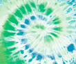 Spiral tie dye pattern in green and blue. 