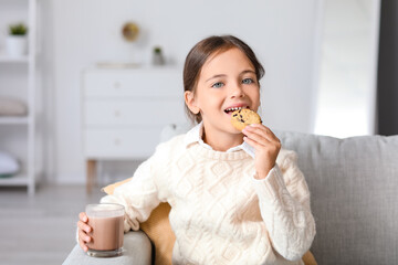 Canvas Print - Little girl drinking tasty chocolate milk and eating cookies at home