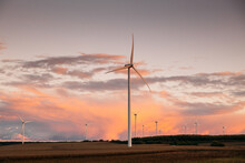 Sunset Over Windmills. Innovative Energy Creator For Electric Power Production.