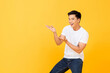 © Atstock Productions - Portrait of smiling young handsome Asian man looking at camera and presenting with open palms gesture in isolated studio yellow background with copy space