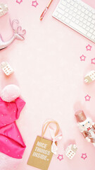 Wall Mural - Christmas holiday feminine pink theme desktop workspace with lady santa hat and accessories on stylish pink textured background. Top view blog hero header creative composition flat lay. Copy space.