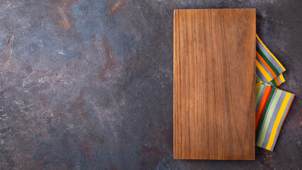 Wall Mural - Empry wooden board with napkin. Top view. Copy space