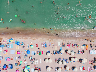 Wall Mural - Aerial View Of People And Colorful Umbrellas On Ocean Seaside Beach In Summer