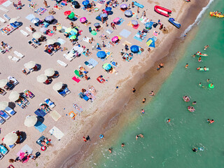 Wall Mural - Aerial View Of People And Colorful Umbrellas On Ocean Seaside Beach In Summer