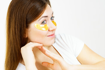 Wall Mural - Woman with gold patches under eyes