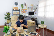 © Pichsakul - start up small business asian man young entrepreneur preparing parcels packing cardboard box for delivery process for send order to customer at home office, Online marketing.