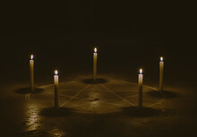 White Pentagram Symbol On Concrete Ground. Illuminated With Candles. Dark Background. Scary, Mystical Occultism 