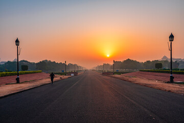 Wall Mural - View at sunrise from rajpath 'King's Way' is a ceremonial boulevard in New Delhi, India that runs from Rashtrapati Bhavan on Raisina Hill through Vijay Chowk and India Gate