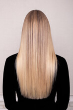 Female Back With Long Straight Blonde Hair In Hairdressing Salon