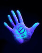 © James Thew - Stop the spread of disease. A human hand glowing from UV ultra violet light showing bacteria and viruses. wash your hands Concept.