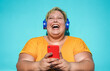 © DisobeyArt - Curvy woman laughing and using smartphone outdoor - Young overweight female having fun listening music playlist on mobile phone