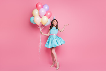 Full length photo of pretty funny lady event party hold air balloons celebrate birthday overjoyed emotions wear blue teal mini dress skirt high-heels isolated pink color background