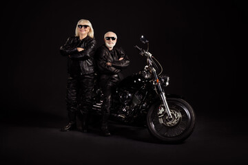 Poster - Portrait of his he her she nice attractive trendy cool cheerful content grey-haired couple married spouses team hipsters chopper travelers folded arms isolated over black color background