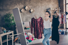 Portrait Of Her She Nice Attractive Doubtful Girl Holding In Hand Two New Chic Podium Festal Dress Looking At Mirror Flattering Choosing Vs Comparing In Modern Loft Industrial Interior Apartment
