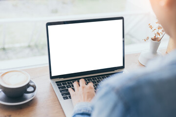 computer mockup blank screen.hand woman work using laptop with white background for advertising,contact business search information on desk at coffee shop.marketing and creative design