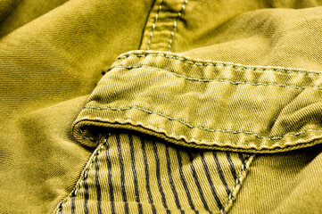 clothing items stonewashed cotton fabric texture with seams, clasps, buttons and rivets, macro