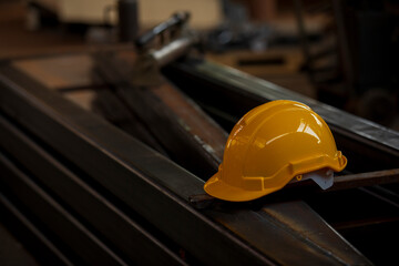 Yellow safety helmet on steel structure at construction site,yellow hard safety helmet hat,safety in construction site