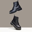 © eugenepartyzan - Black boots in the air. fashion shoes still life