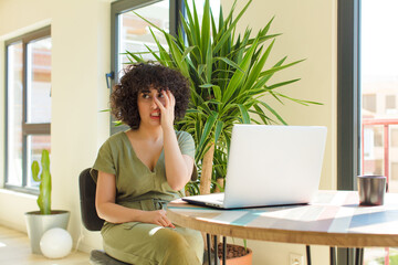 Wall Mural - young arab woman working at home with a laptop