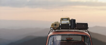 Traveler Car With Roof Rack And Things In Retro Style On Mountains Background