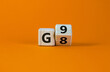 Symbol for the duration of the secondary school in Germany. Expanded wood cube with G8 '8 years' to G9 '9 years' or vice versa on beautiful orange background, copy space.  Educational concept.
