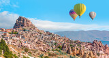 Fototapeta Góry - Hot air balloon flying over spectacular Cappadocia