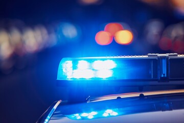 Siren light on roof of police car at street. Themes crime, emergency and help.