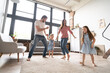 © opolja - happy family mother father and child daughter dancing at home