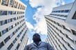 © Cavan Images - African American businessman between buildings.