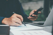 © Cavan Images - Closeup businessman working with modern device