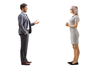 full length profile shot of a man gesturing with hand and talking to a blond young woman
