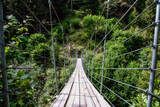 Fototapeta Most - wooden suspension bridge in the forest beautiful mountain landscape